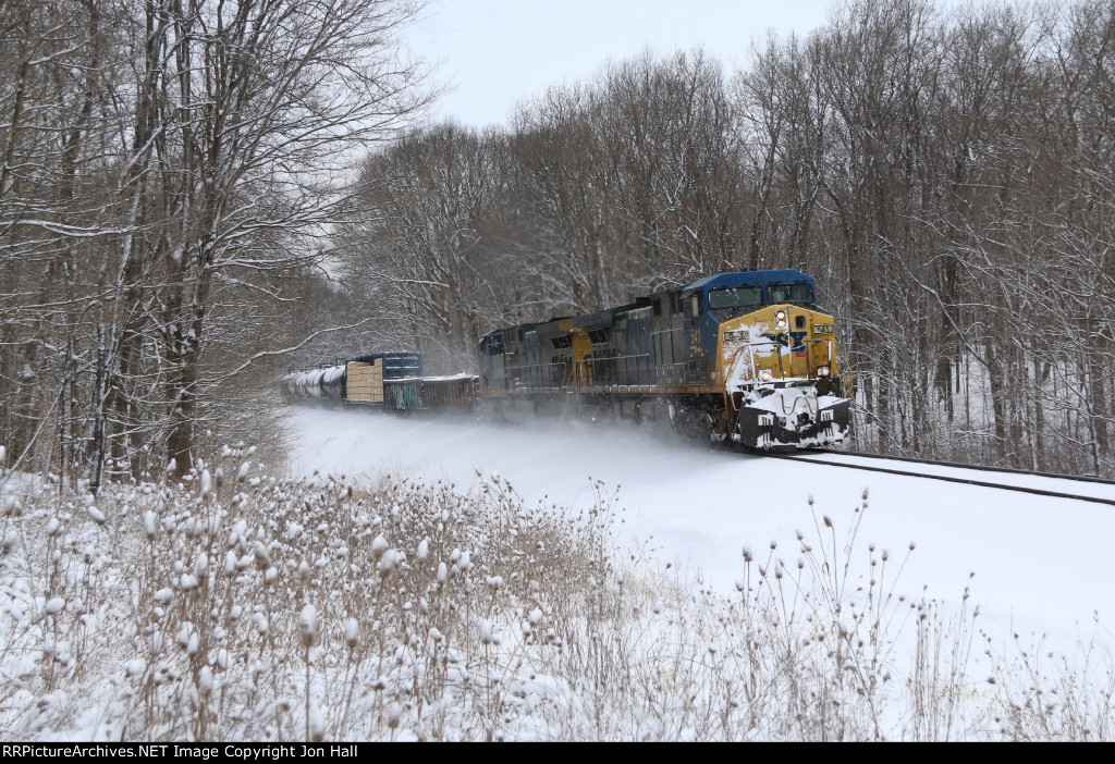 Climbing away from the Kalamazoo River, CSX 541 leads Q327 through the snow covered landscape